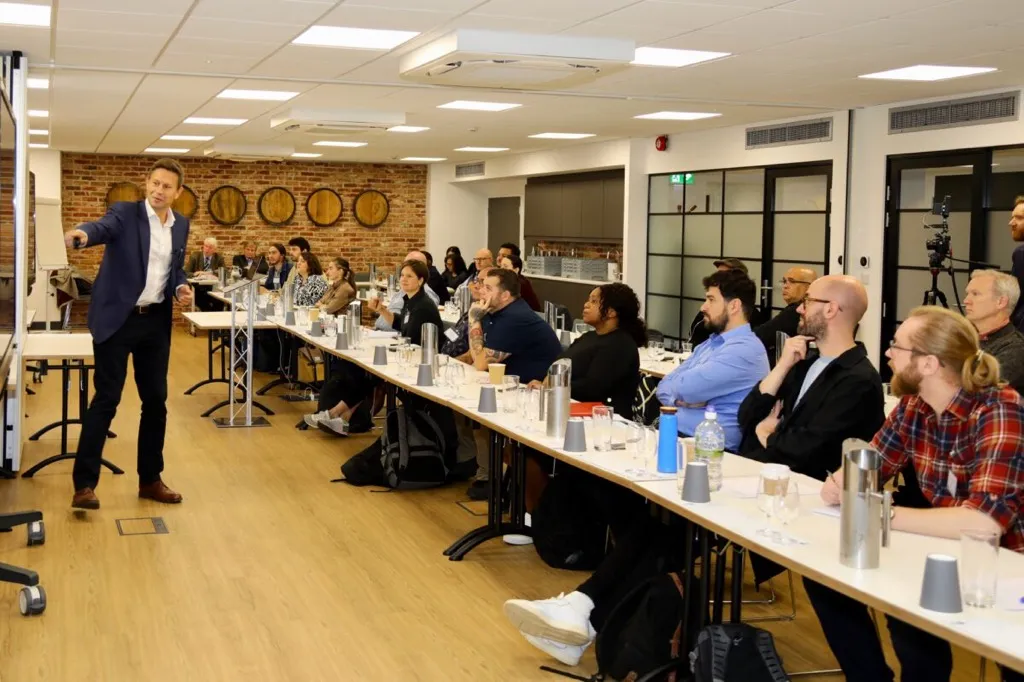 A speaker presenting to an audience at a Business of Spirits seminar